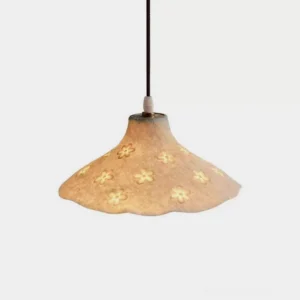 Floral cutout pendant light with wavy rim and textured ivory resin shade, studio front view showing intricate flower hollow carvings and soft diffused illumination