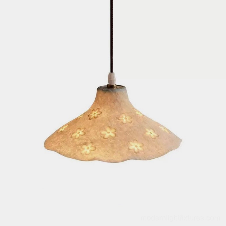 Floral cutout pendant light with wavy rim and textured ivory resin shade, studio front view showing intricate flower hollow carvings and soft diffused illumination