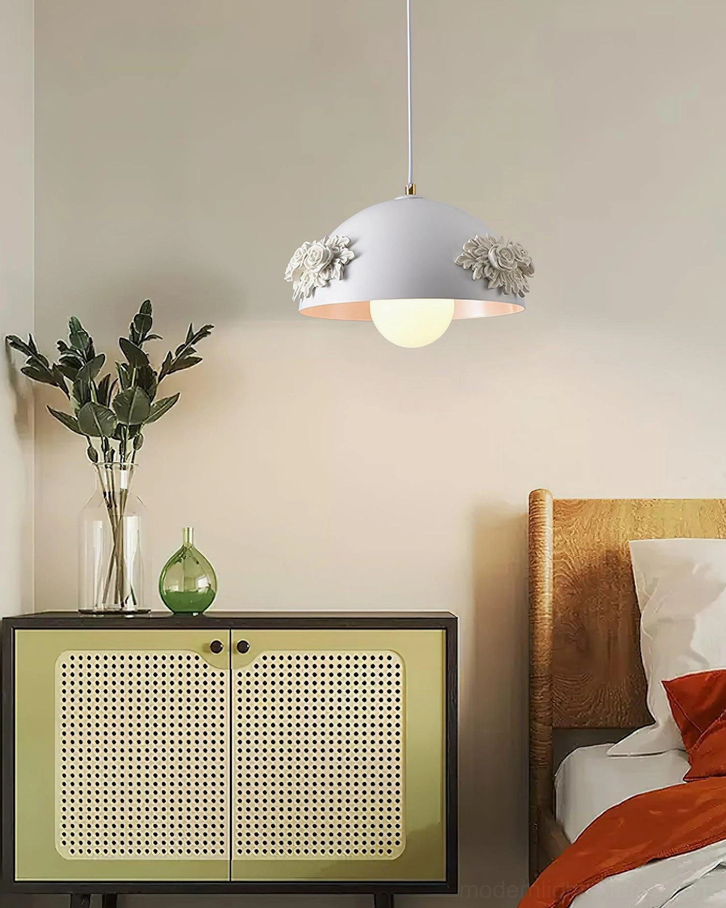 Floral dome pendant light fixture shown on warm beige wall background, white acrylic shade with rose appliqué and gold hardware