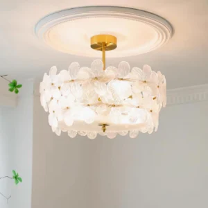 Modern floral ceiling light fixture installed in residential room with ceiling medallion, showing warm illumination