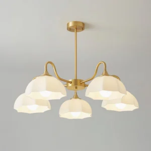 Close-up detail of 5-light modern chandelier showing fired glass shades with floral motifs and matte brass frame
