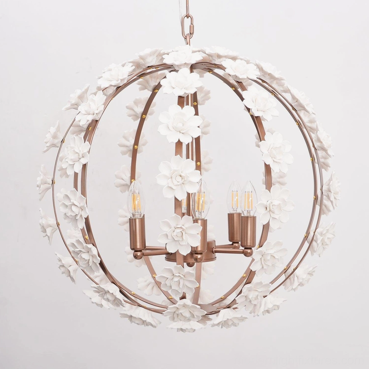 Illuminated ceramic flower globe pendant light with warm candle bulbs close-up detail