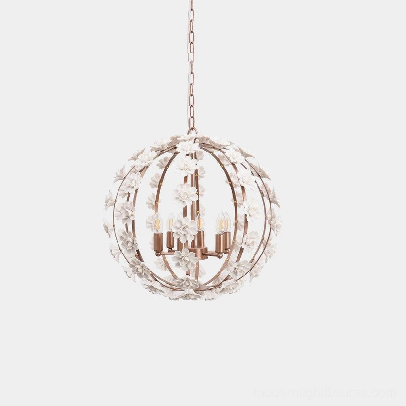 Floral ceramic globe pendant light with white and rose gold metal frame, frontal studio view