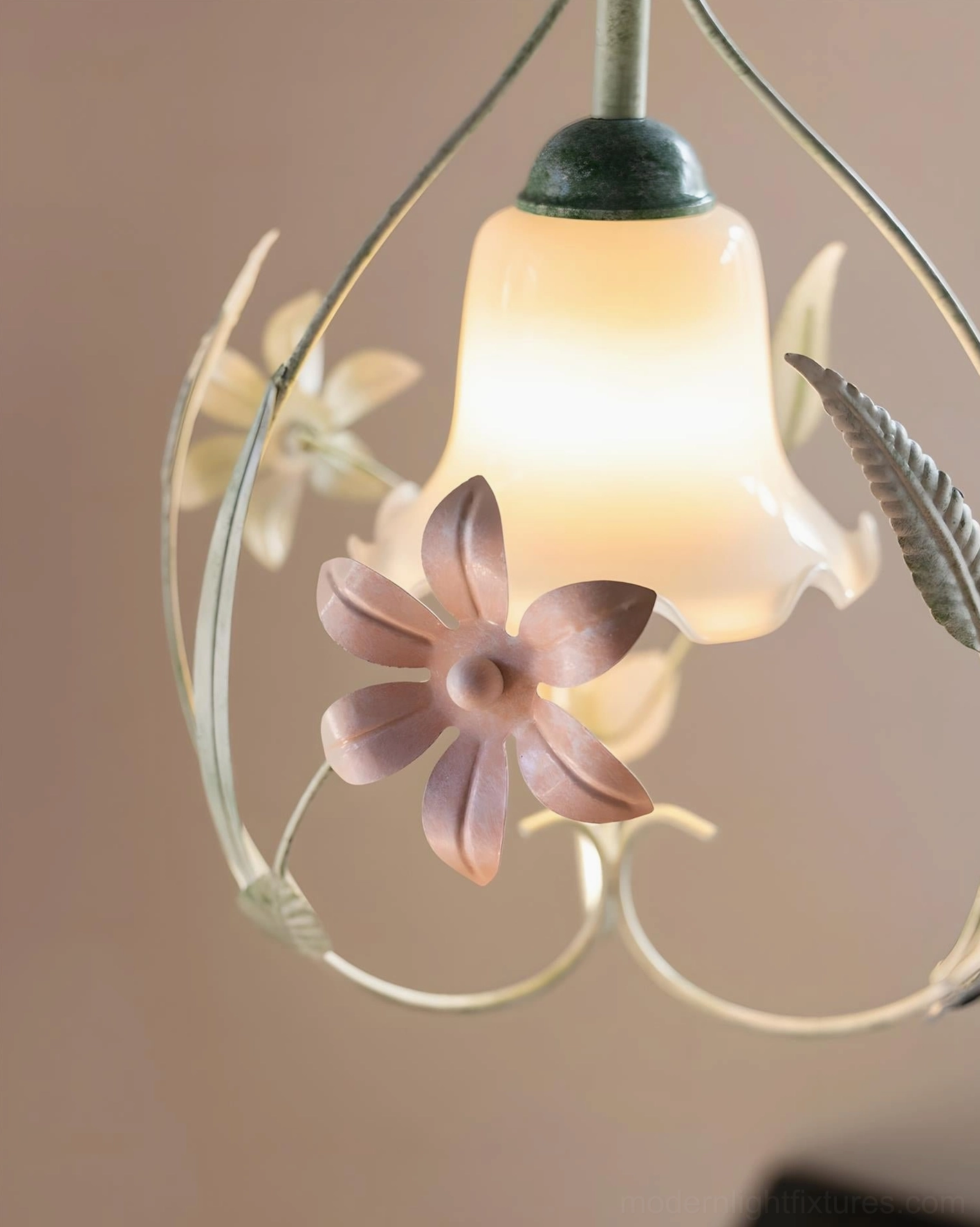 Overhead close-up of floral pendant fixture showing bell-shaped frosted glass shade with painted flower and leaf botanical accents