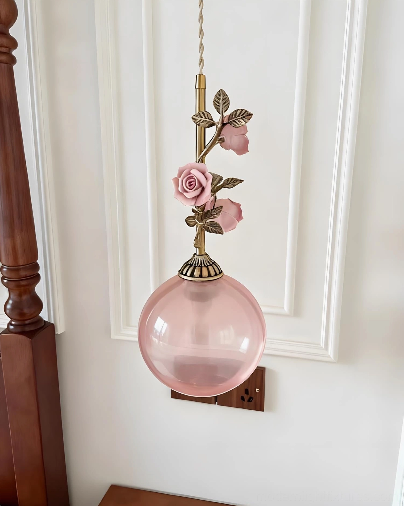 Floral pendant light installation above dining table, elegant fixture placement