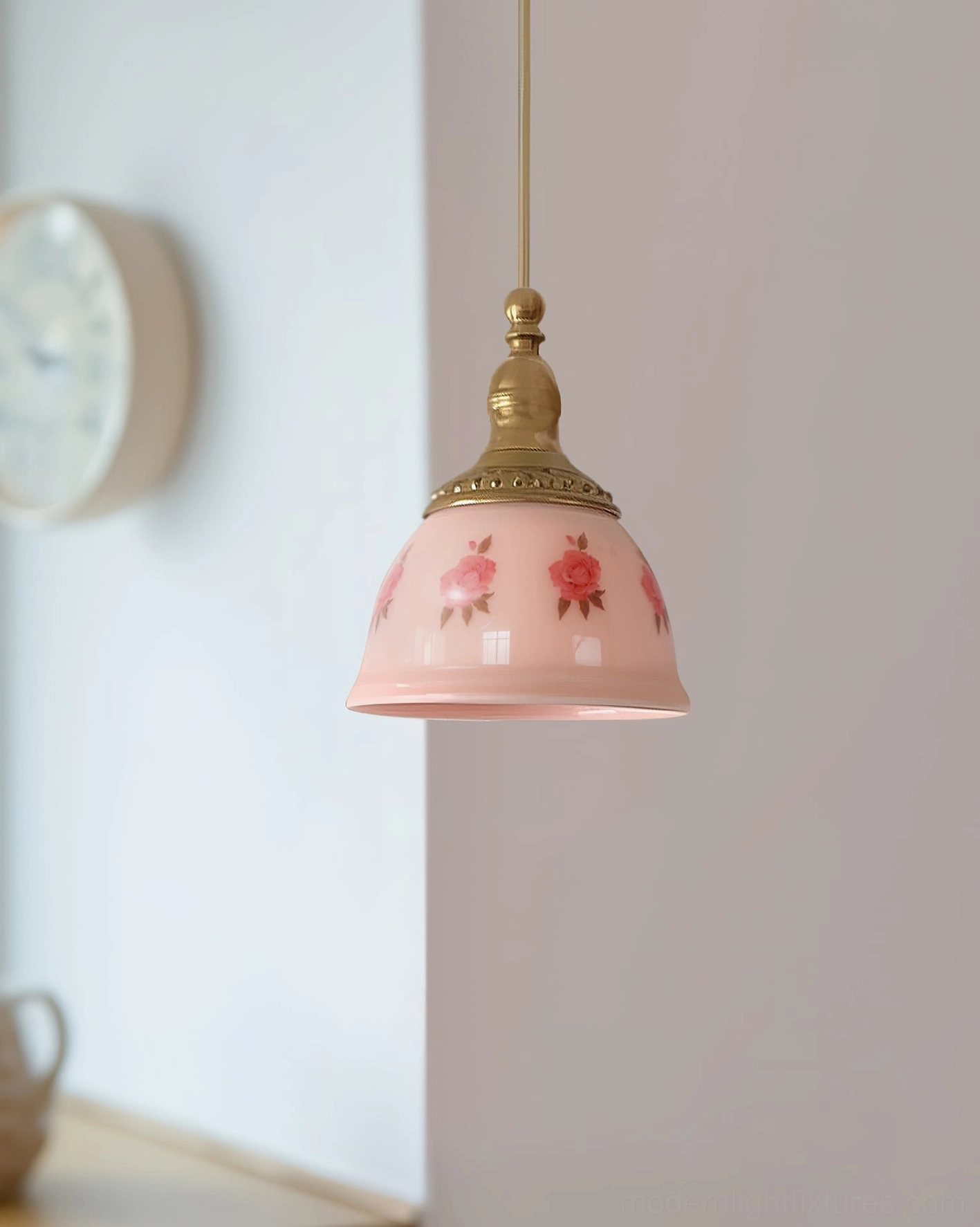 Floral ceramic pendant light installed in home interior above table with wall clock and decorative accents