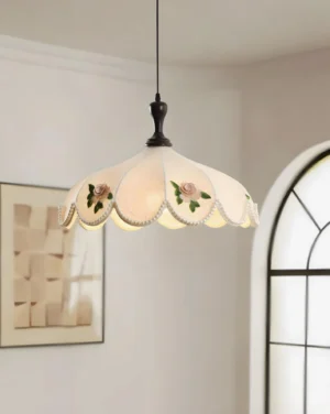 Romantic fabric pendant lamp with scalloped edge detail and rose embroidery displayed in elegant vintage dining room with arched window