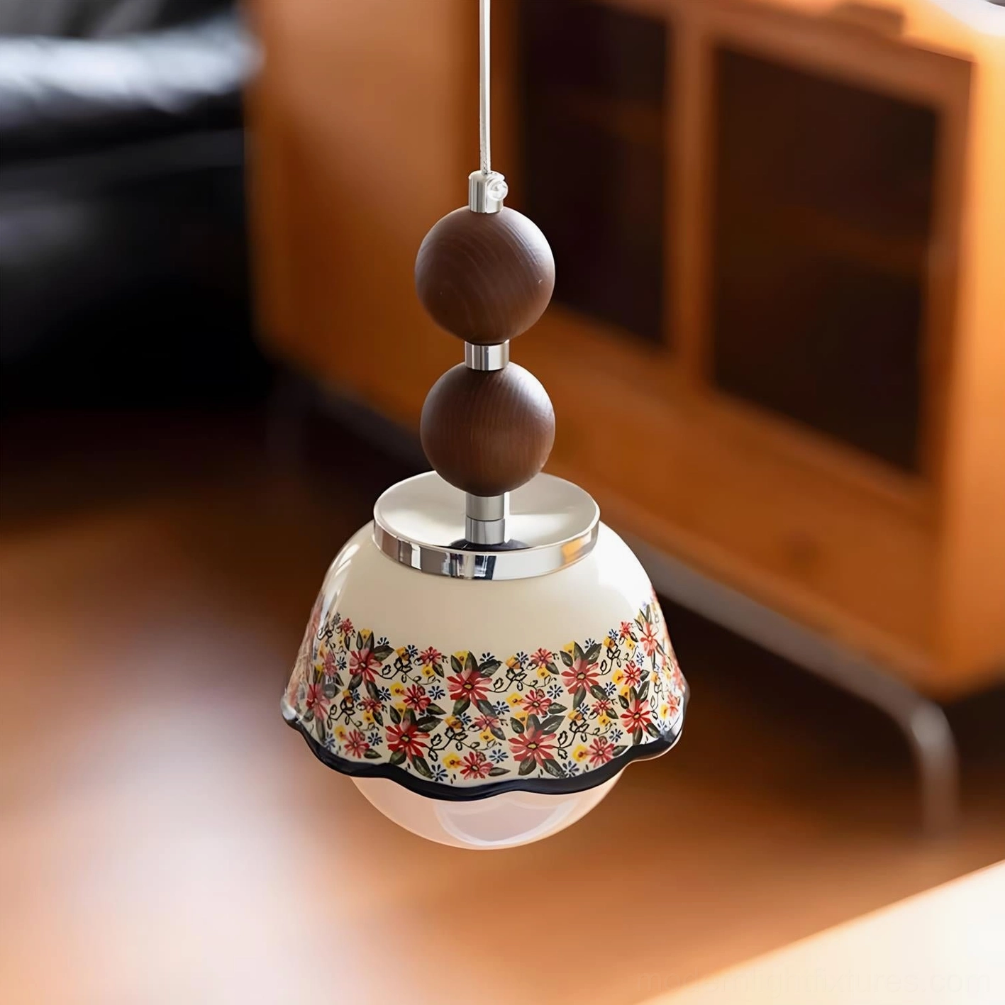 Vintage-style Bellora pendant light hanging in home interior above wooden cabinet with warm ambient lighting and dark walnut wood bead accents, mid-century rustic aesthetic