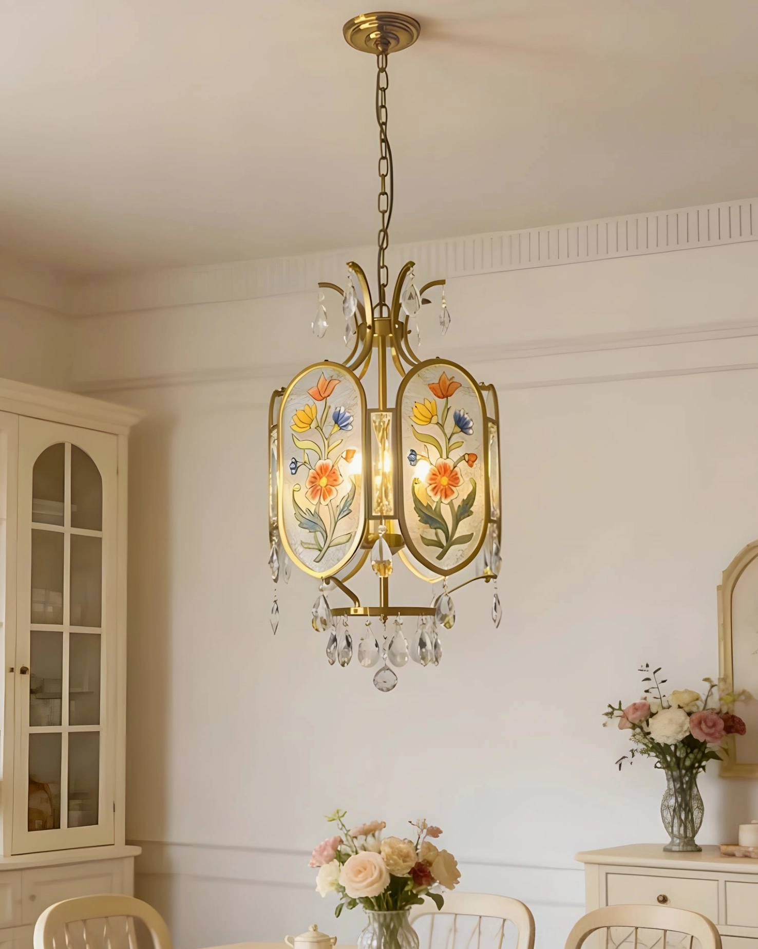 Low angle view of Jardinelle hand-painted floral pendant light showing intricate glass detailing and crystal accents in warm home setting