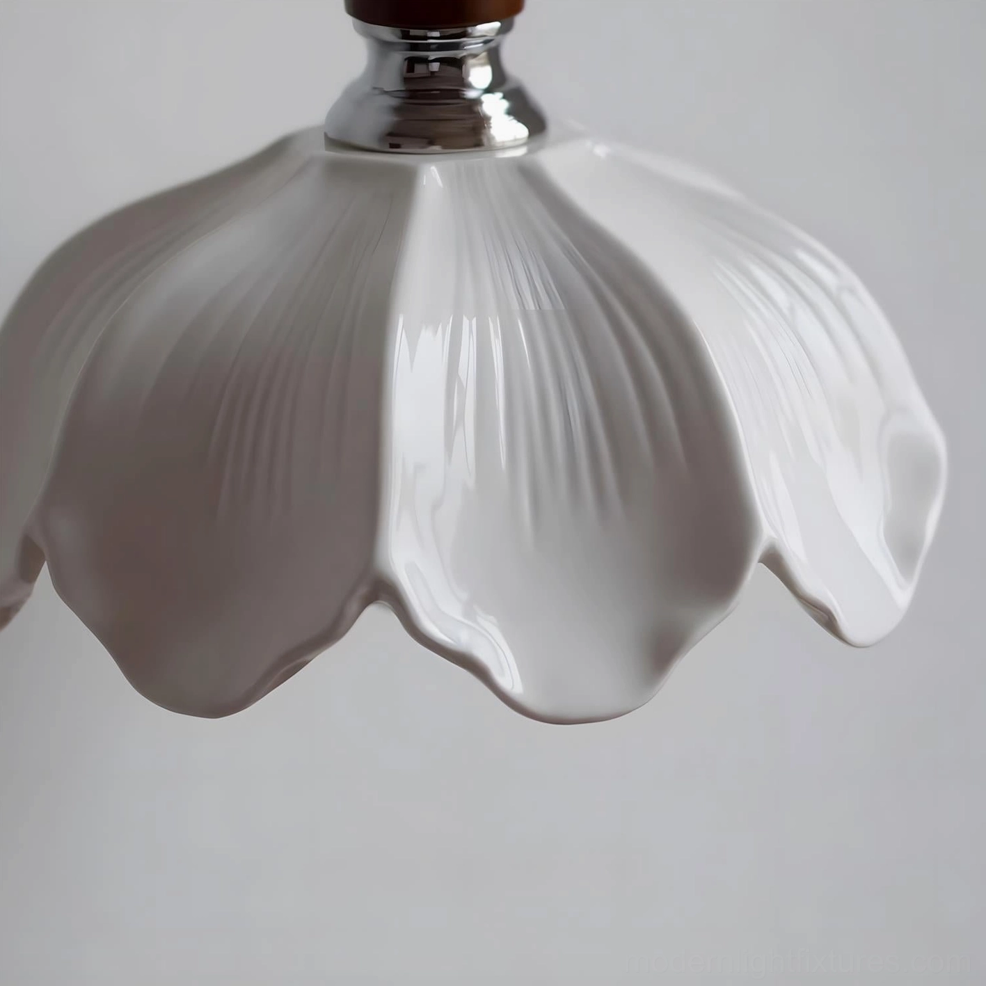 Ceramic floral wall sconce in neutral home decor scheme with warm lighting and botanical styling