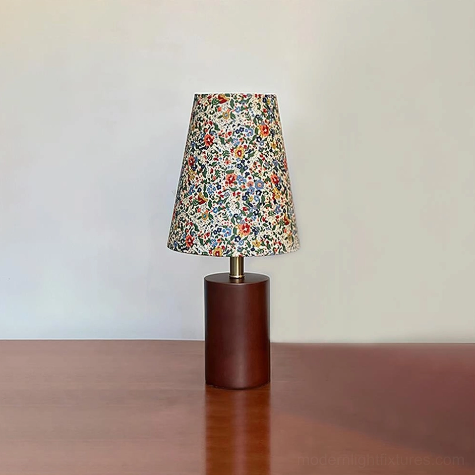 Modern floral table lamp with cylindrical wooden base in minimalist tabletop studio setting