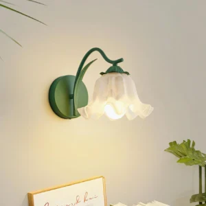 Botanical wall light fixture installed in contemporary home interior with plant décor