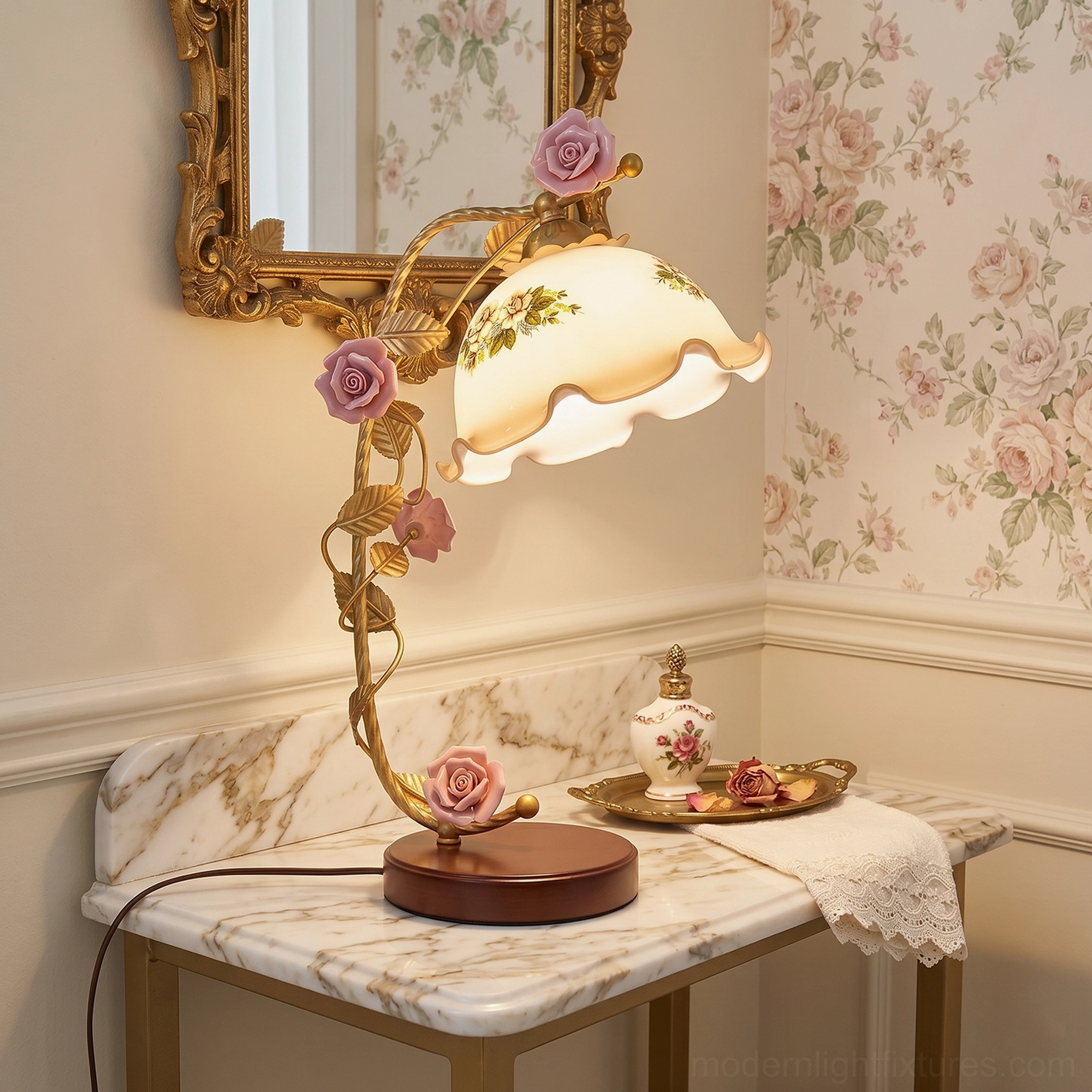 Vintage Florielle rose table lamp positioned on marble-top vanity with gilded mirror, antique gold frame detail