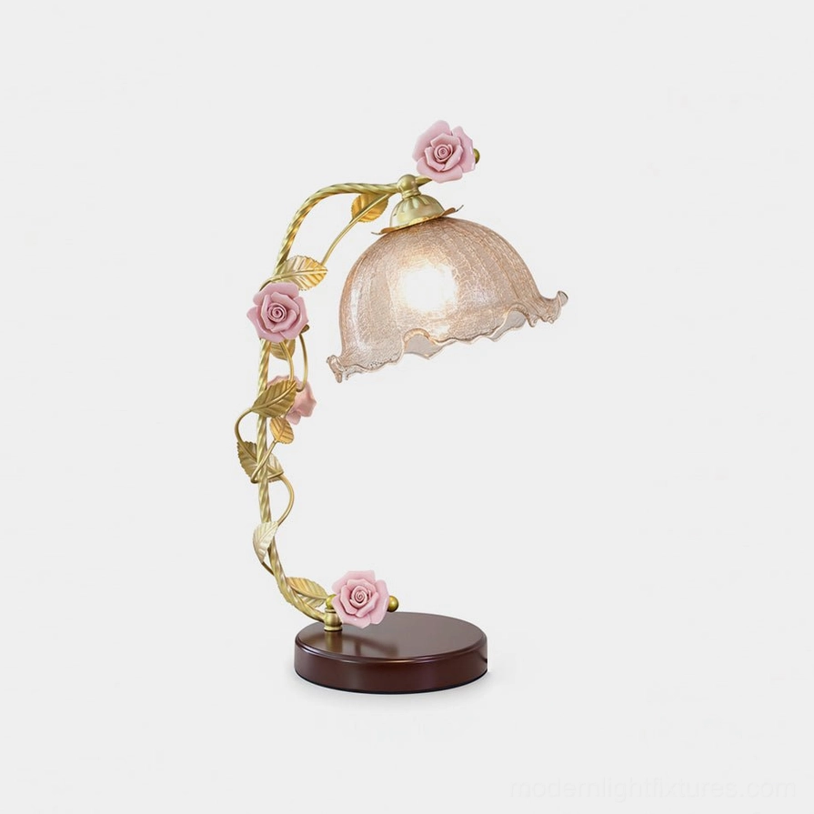 Florielle porcelain rose table lamp with antique gold accents and petal-edged glass shade, front view on white studio background