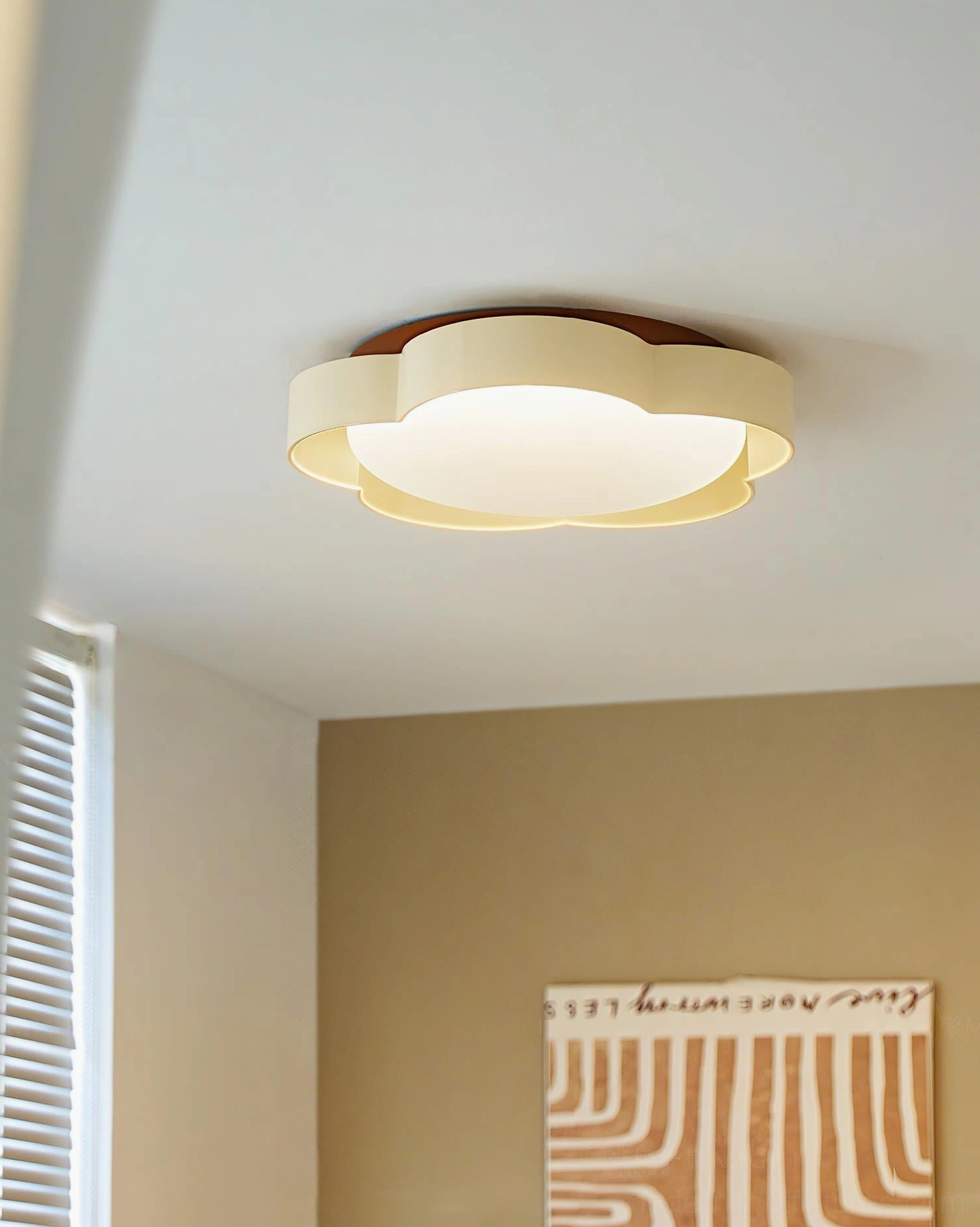 Flower ceiling lamp installed in warm neutral bedroom - modern flush mount light with wood trim