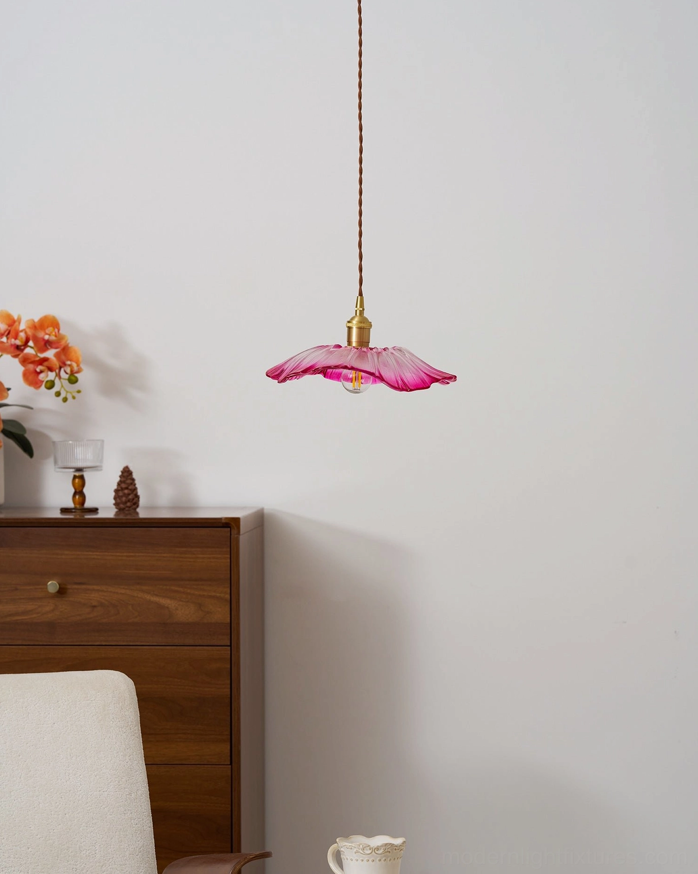 Flower glass pendant light creating layered lighting in modern bedroom space