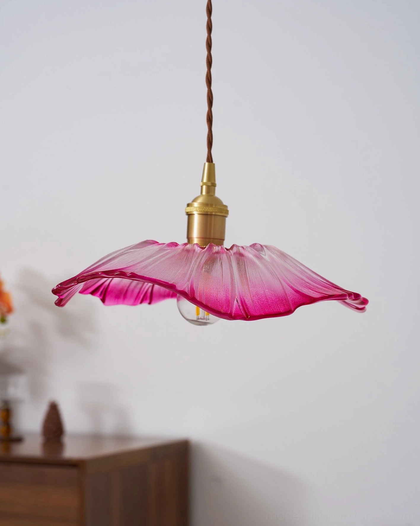 Flower glass pendant light in minimalist interior with soft diffused lighting