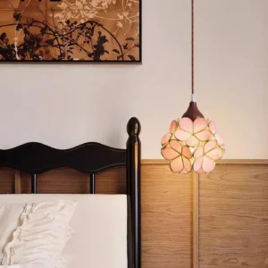 Floral stained glass pendant light hanging in vintage bedroom, warm ambient lighting with black wooden bed frame