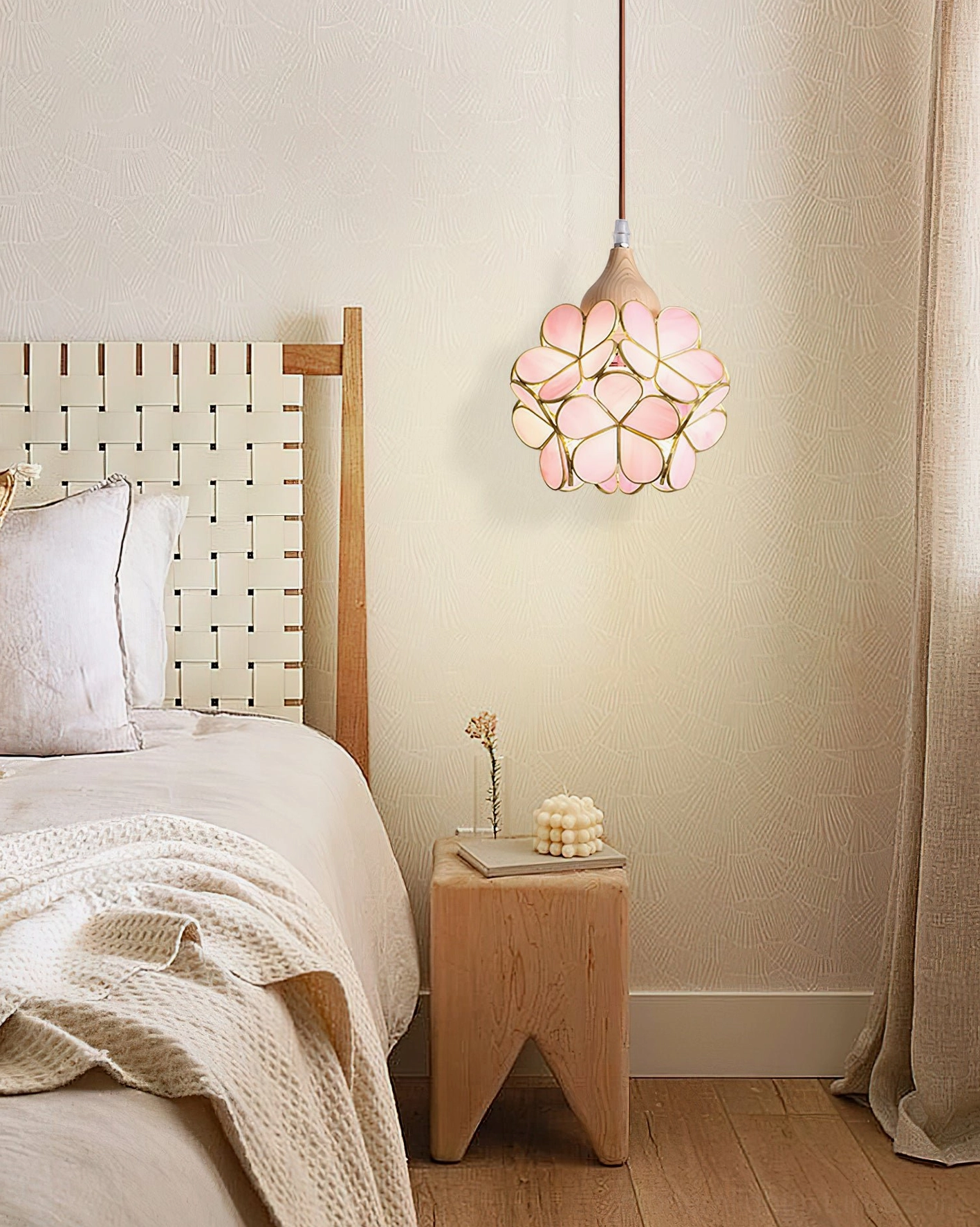 Pink stained glass flower pendant in minimalist Japandi bedroom with light wood furniture and neutral tones