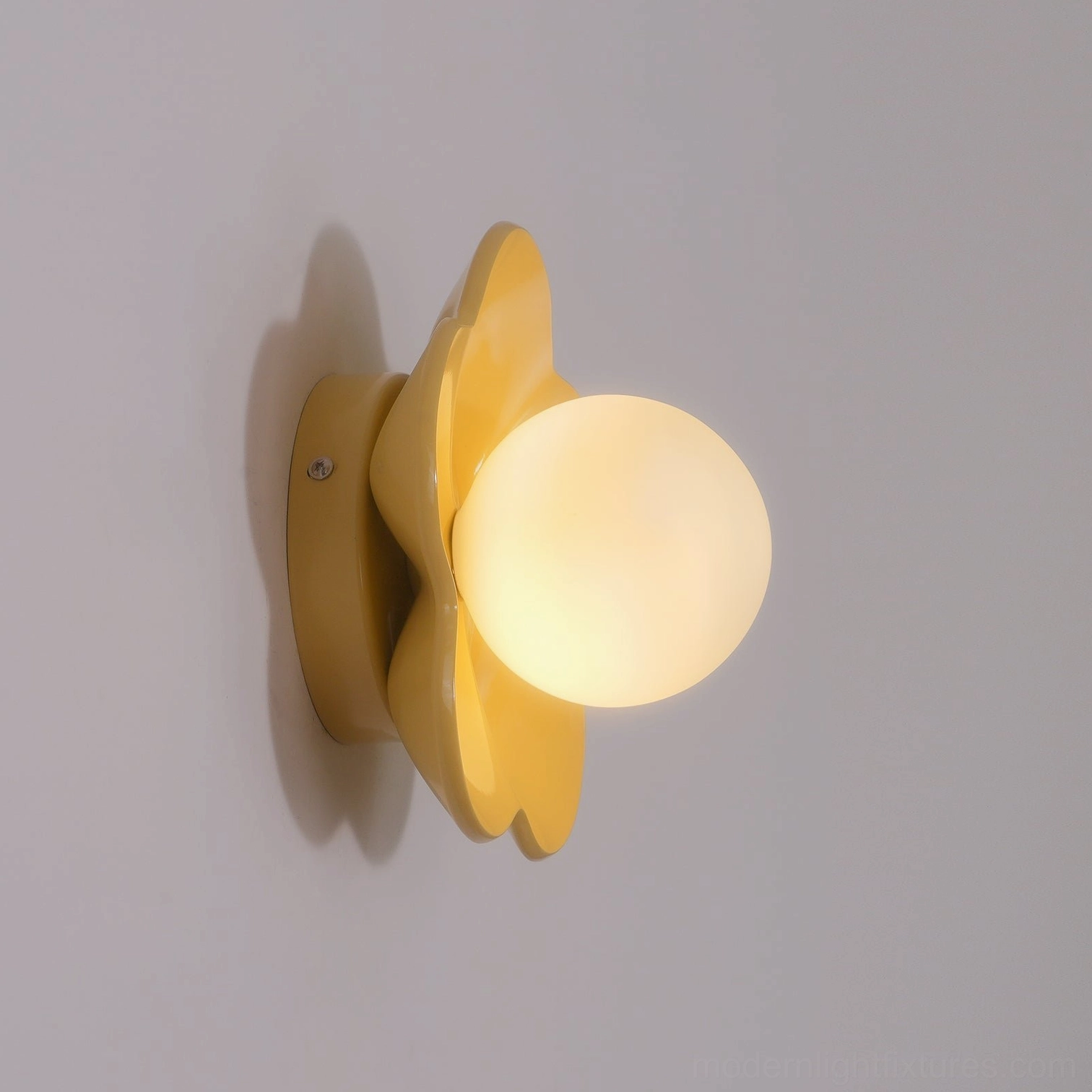 Flower wall lamp styling in contemporary bedroom with neutral decor palette