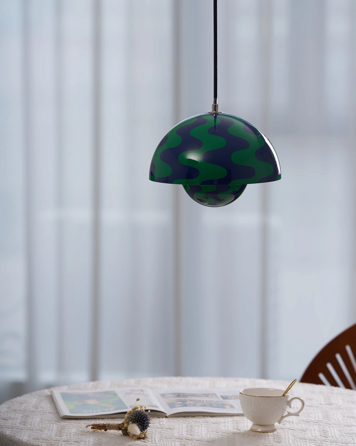 Flowerpot pendant light illuminating dining surface at optimal task lighting height