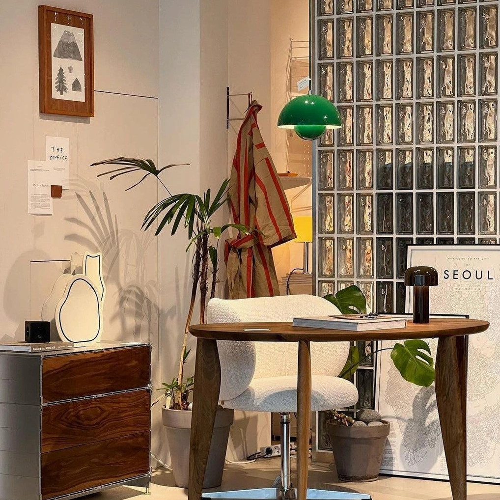Green Flowerpot pendant light suspended in home study corner providing focused task lighting