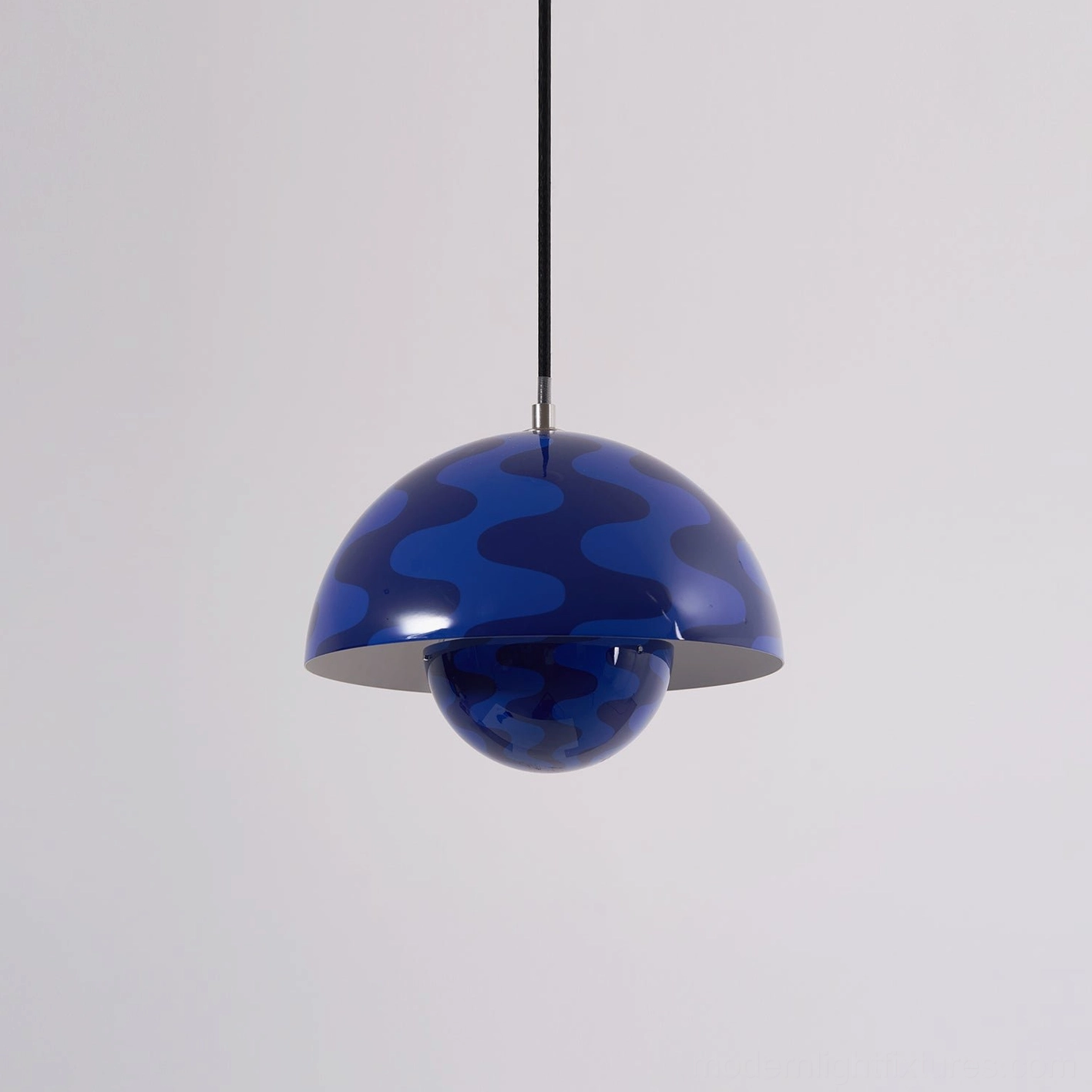 Flowerpot pendant light positioned above modern kitchen island with contemporary styling