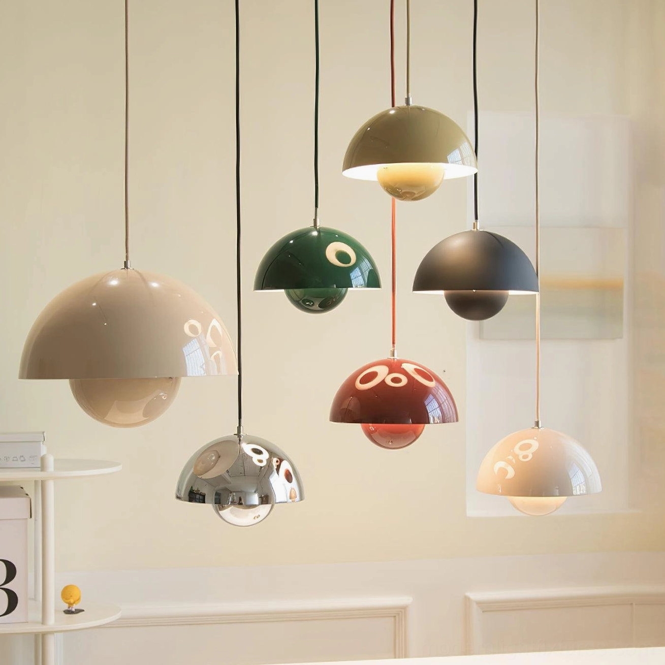Collection of Flowerpot pendant lights in various finishes displayed on indoor wall showcasing color palette