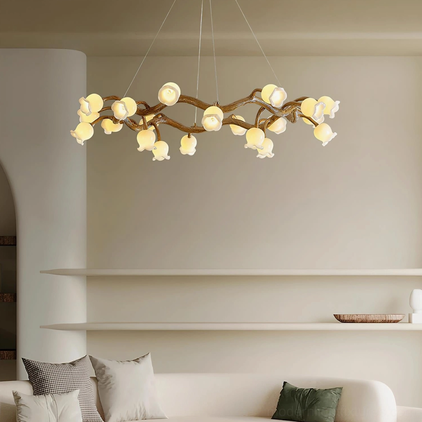 Modern living room with lily of the valley branch chandelier, sofa, and wall shelves