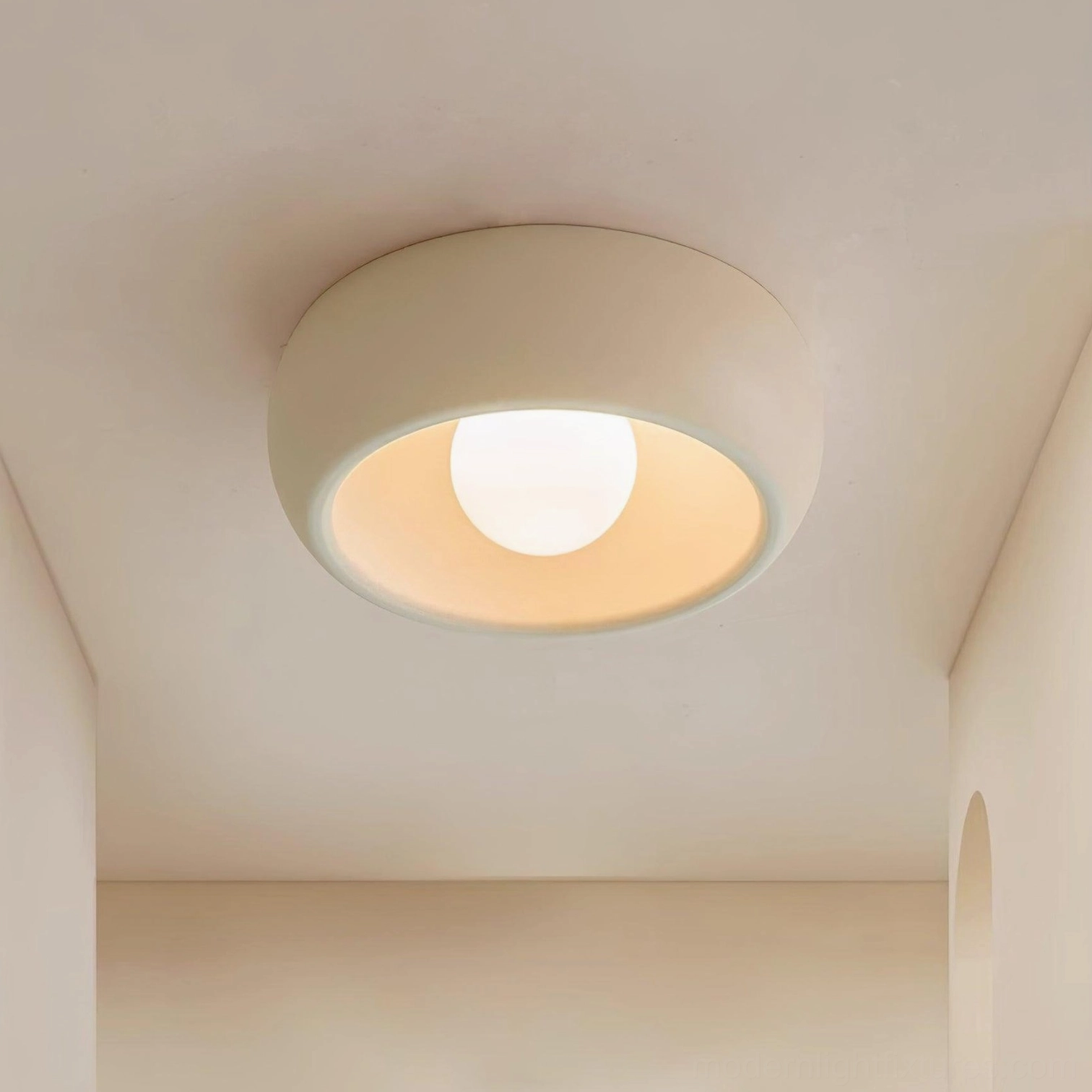 Low-profile ceiling light fixture installed in residential corner, demonstrating compact 4.3 inch profile and warm ambient illumination
