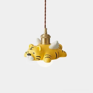 Winged tiger pendant light with matte yellow resin shade and brass metal socket on white background