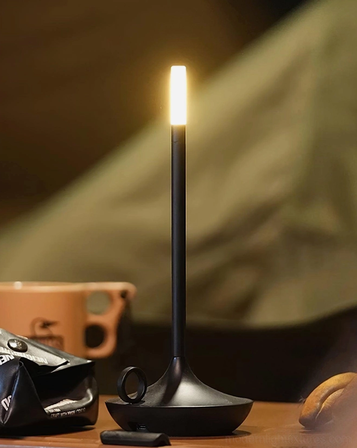 Contemporary LED table lamp providing focused warm illumination for home office workspace area