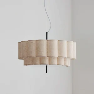 Modern fabric pendant light with scalloped pleated linen shade in beige, black suspension hardware, interior setting