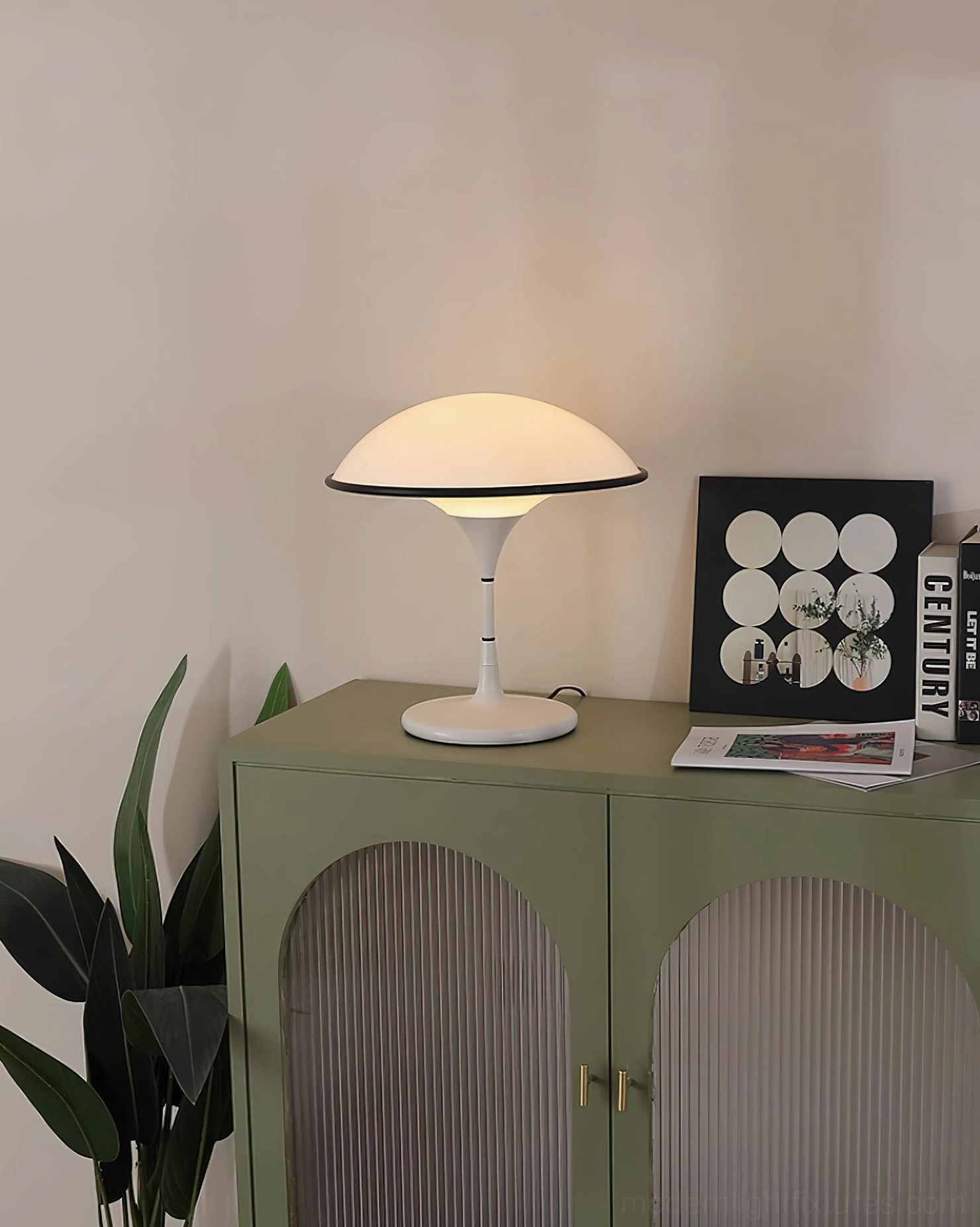 Fontana table lamp on green cabinet side angle with wall art and plants home decor