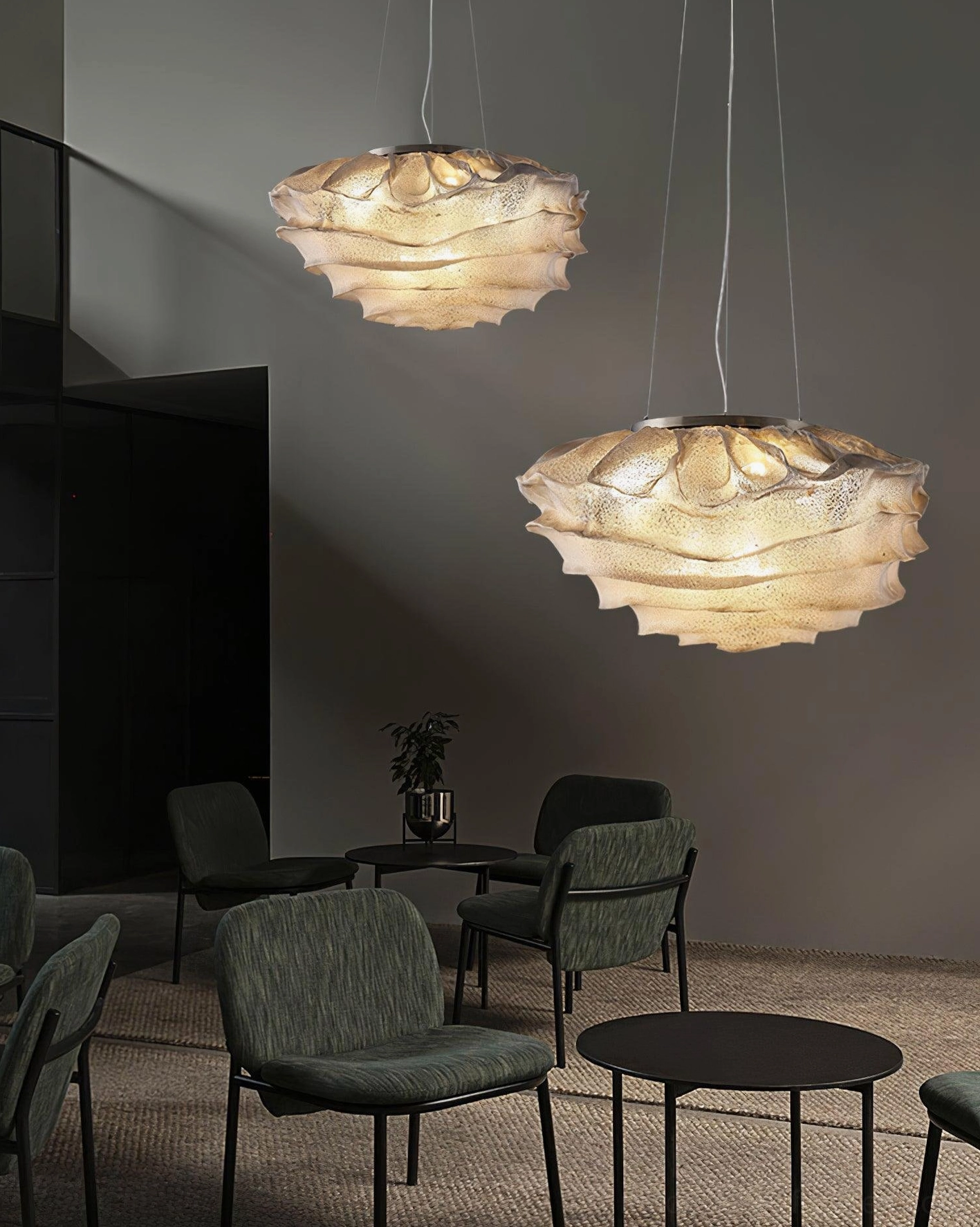 Dual clustered Forsyth ruffled pendant lamps installed for ambient area lighting in modern commercial meeting lounge