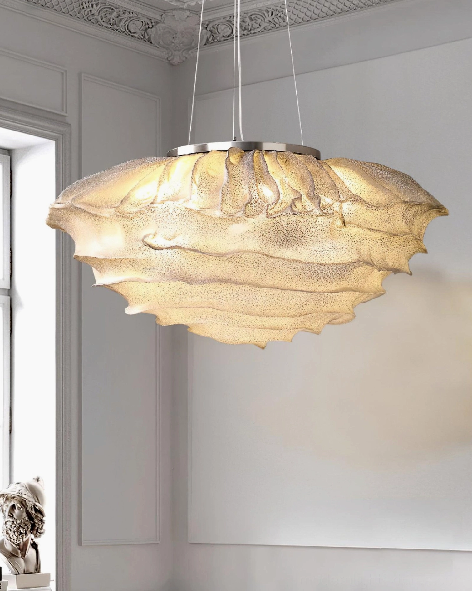Forsyth ruffled glass pendant lamp casting warm ambient light in classic European-style living room with ornate ceiling trim