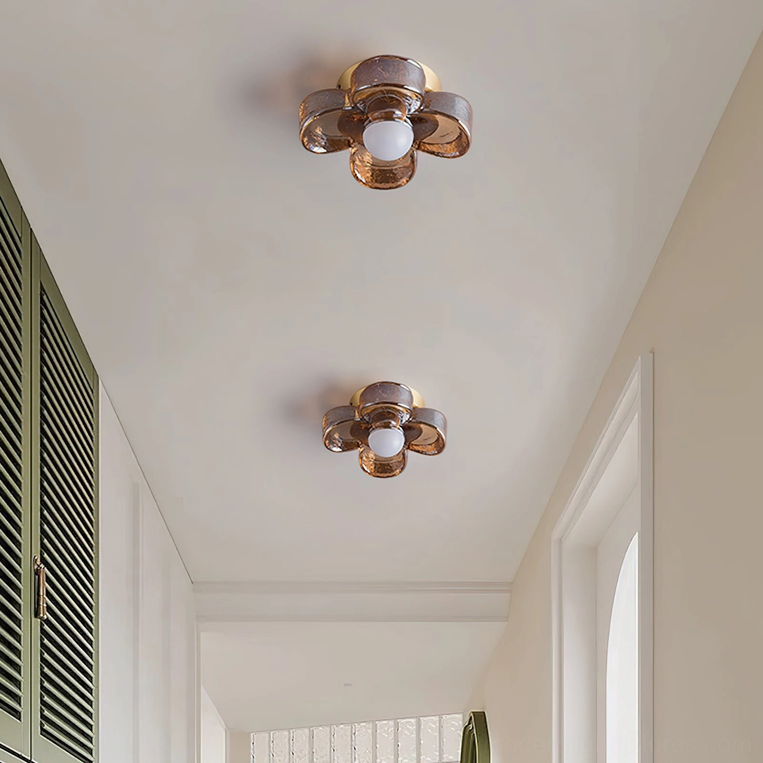 Multiple four-leaf clover ceiling lights installed in residential hallway corridor with matching brass and amber fixtures