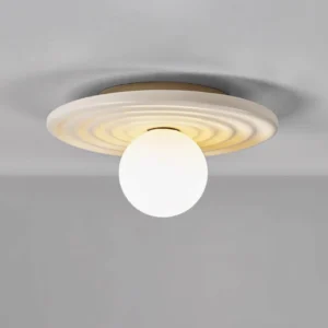 Francie wabi-sabi ceiling light three-quarter angle view showing curved metal body and spherical warm-toned bulb design