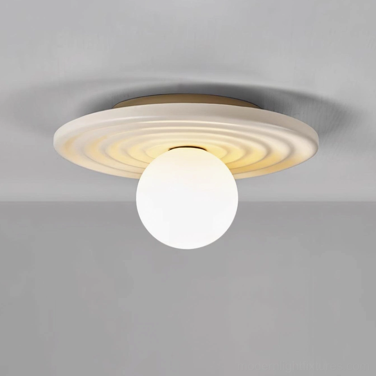 Francie wabi-sabi ceiling light three-quarter angle view showing curved metal body and spherical warm-toned bulb design