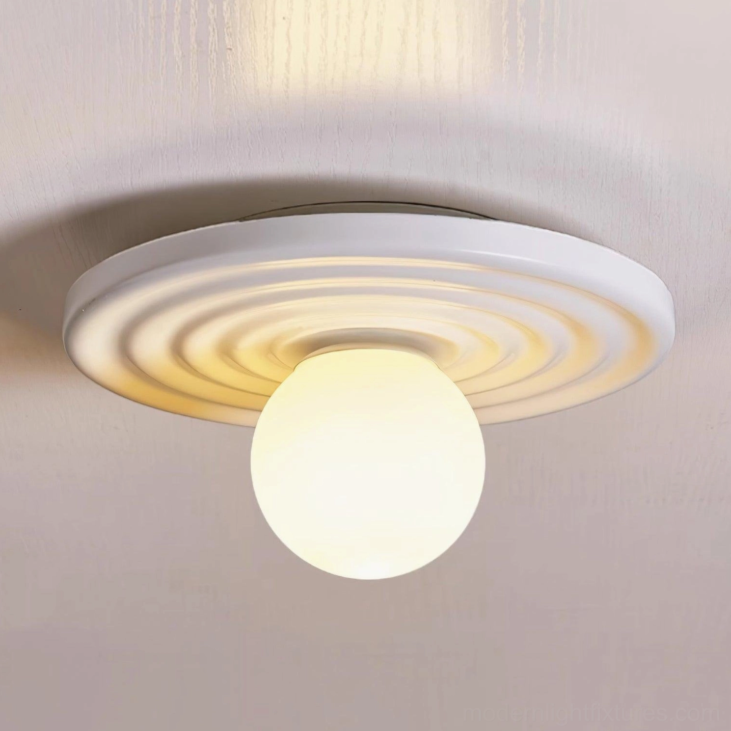 Francie ceiling light fixture in minimalist bedroom setting providing soft ambient overhead illumination