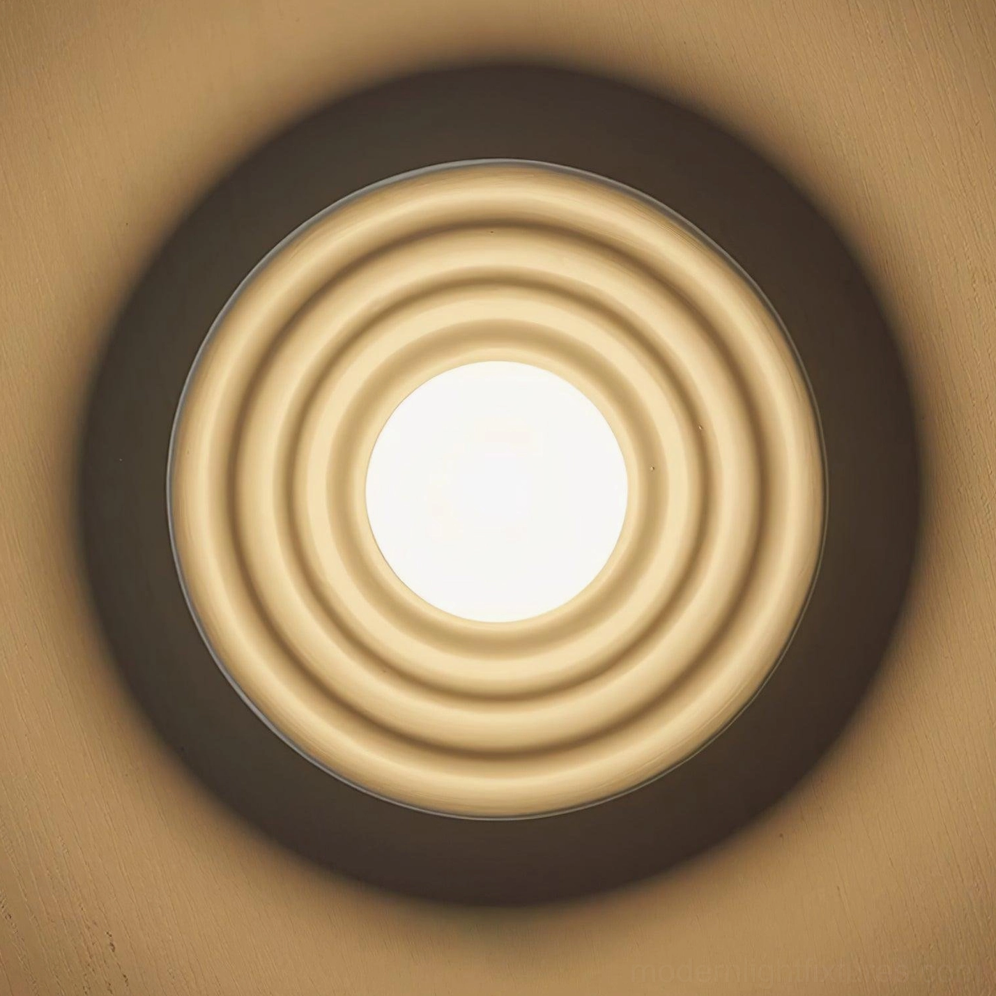 Francie wabi-sabi disc light in brown finish showing warm golden tone and ribbed texture detail under illumination