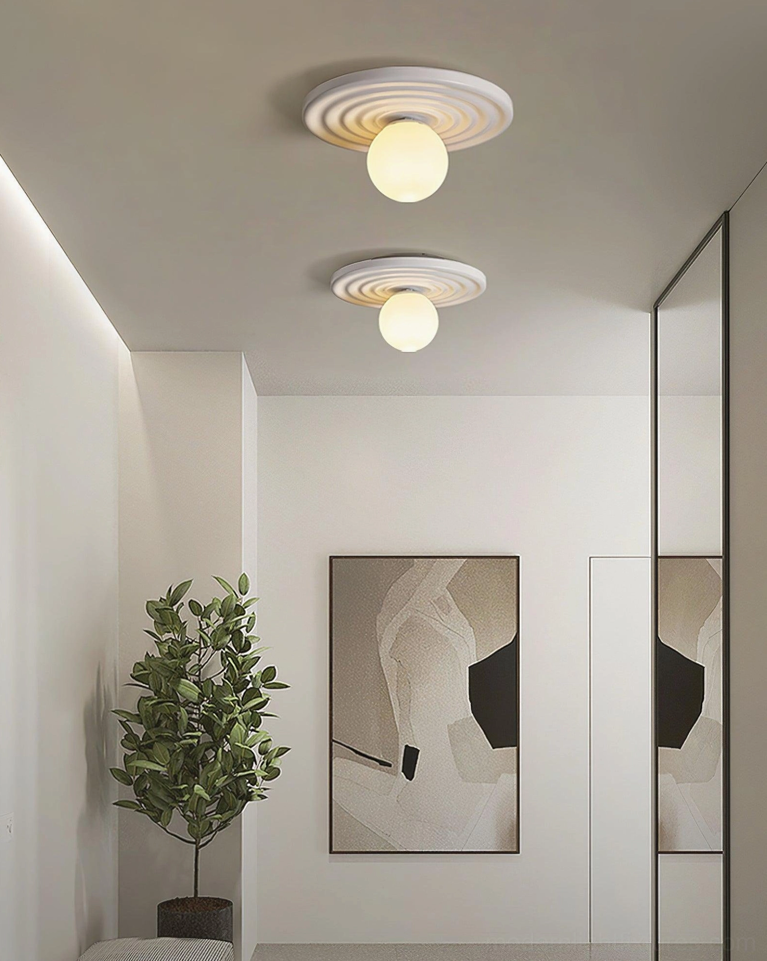 Pair of Francie minimalist ceiling lights installed in modern hallway with neutral decor and contemporary wall art