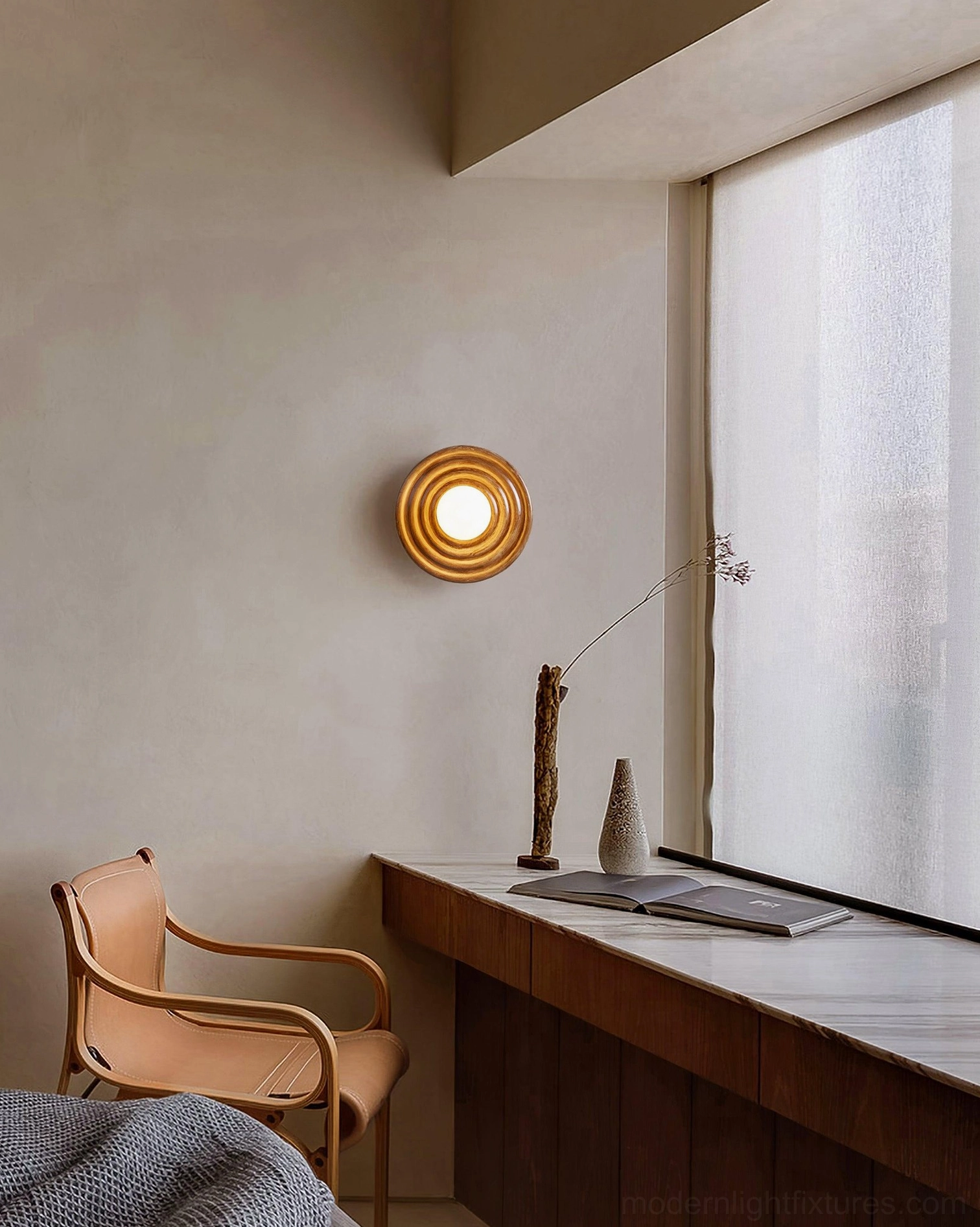 Francie ribbed wall sconce light installed above bathroom vanity mirror with warm gold metal finish