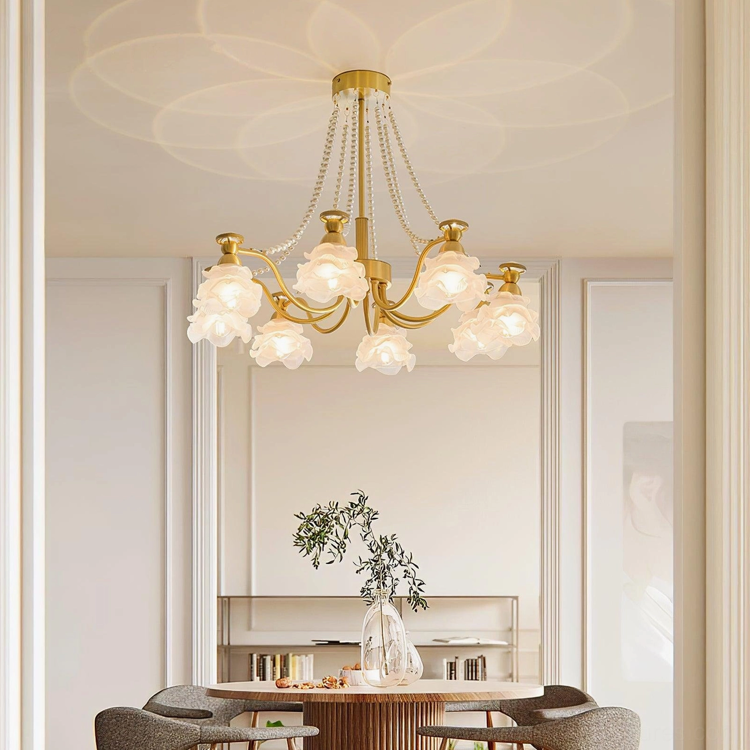 French floral rose pendant light fixture installed in residential dining room - overhead view with warm ambient glow