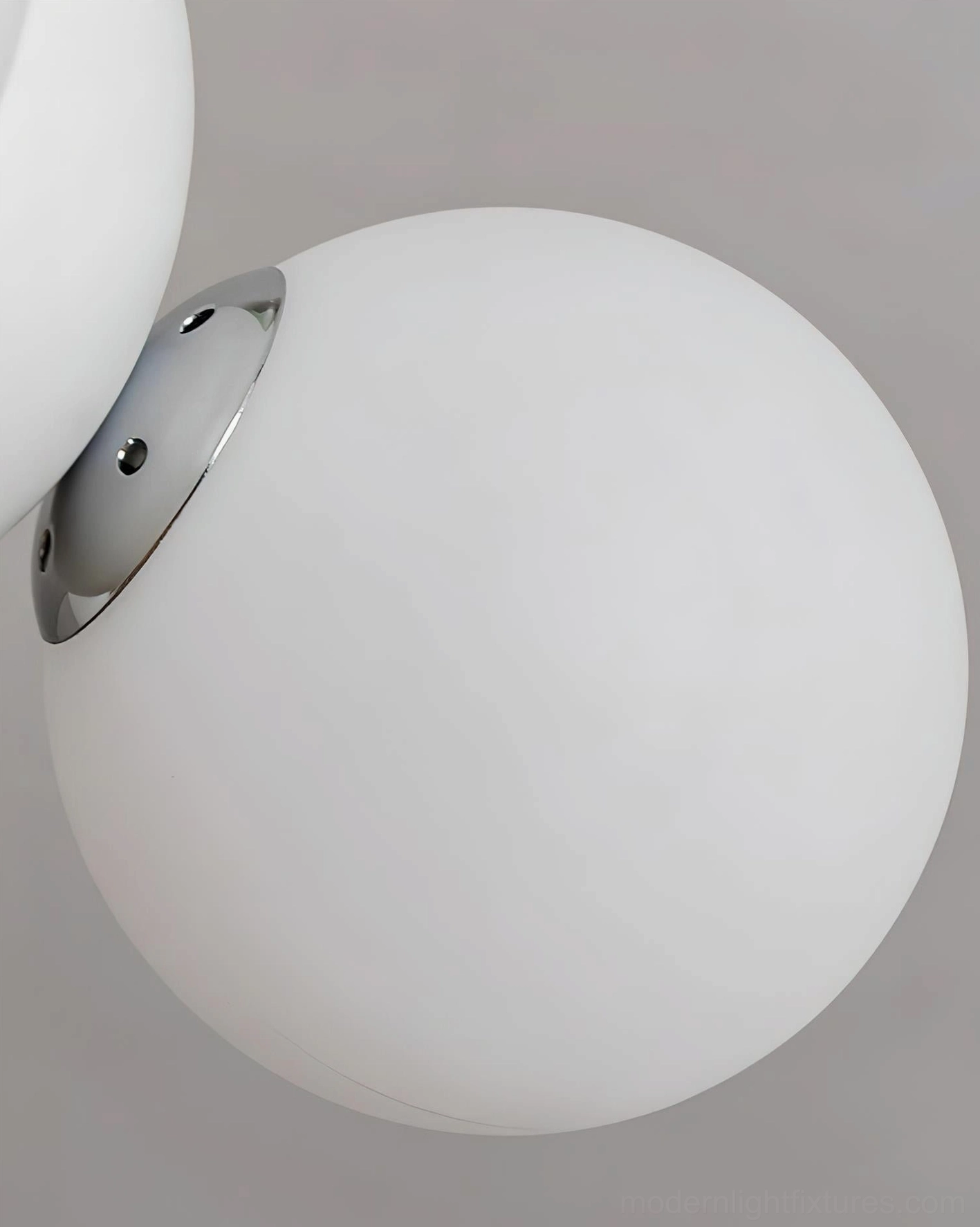 Frosted spherical acrylic glass shade with metal mounting bracket, close-up side angle