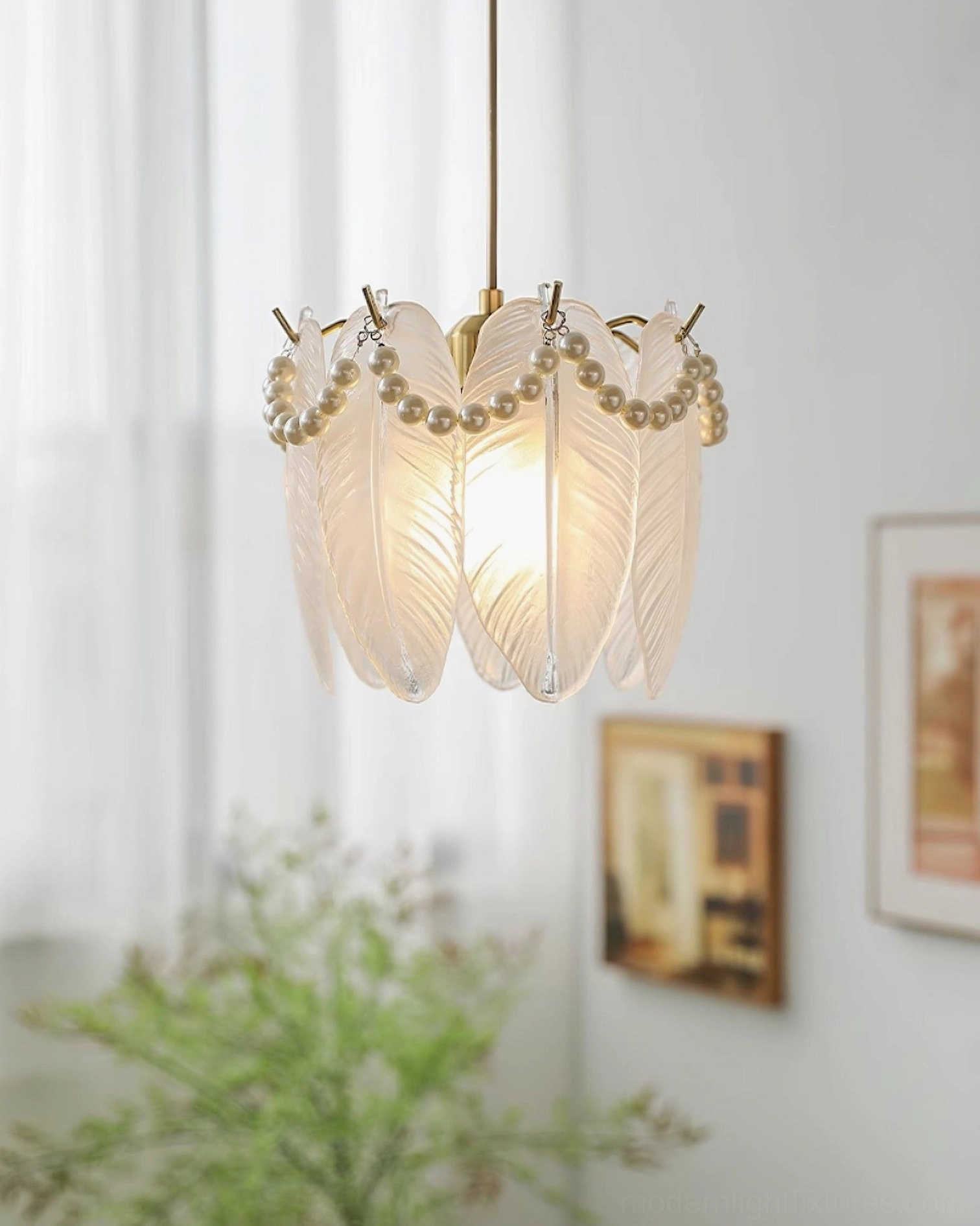 Frosted feather glass petal pendant lamp with pearl beaded trim displayed in home space with warm ambient lighting