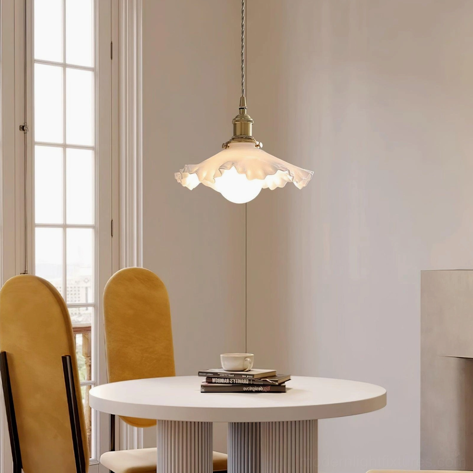 Contemporary frosted glass pendant light with textured ruffled shade hanging above round dining table in small dining room