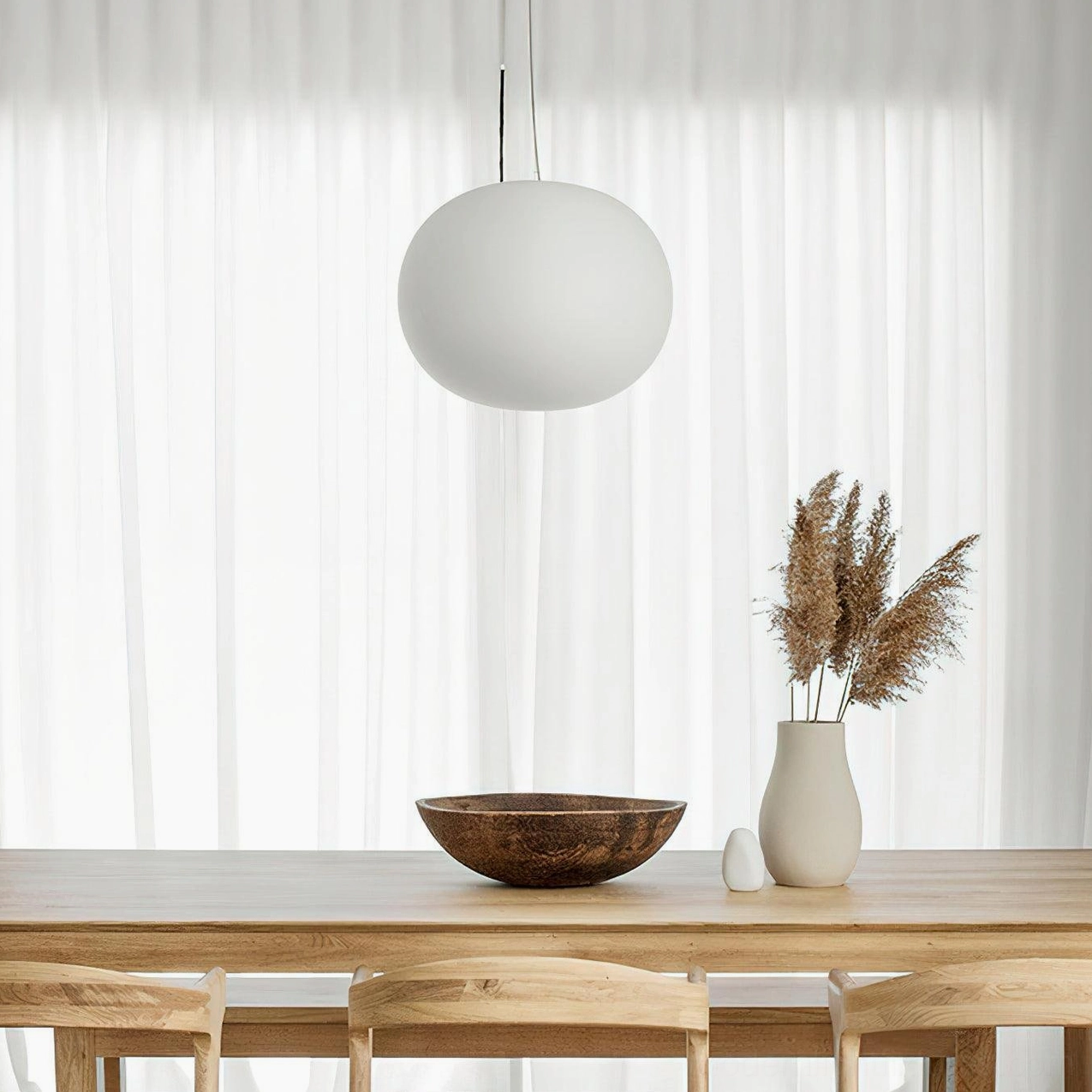 Frosted glass sphere pendant light installation in modern home - soft diffused light from white pendant fixture
