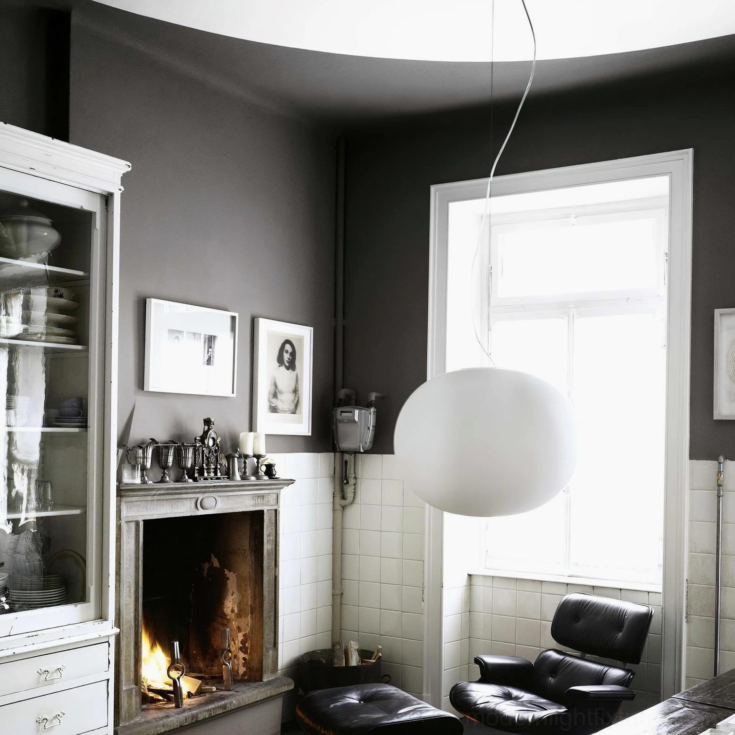 Contemporary frosted glass sphere pendant in minimalist living room - soft warm light in modern interior space