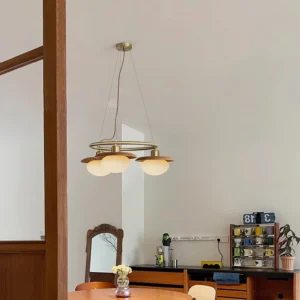 Gama circular pendant chandelier installed in modern dining room with warm neutral decor and natural lighting